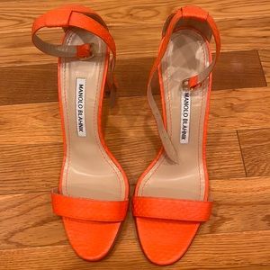 Never been worn outside the house Manolo Blahnik orange heels. 4 inch heel.